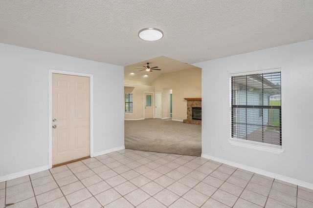 5903 Jack Stokes Rd, Baker, FL 32531 - spare room with vaulted ceiling, a fireplace, ceiling fan, light carpet, and a textured ceiling