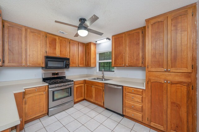 5903 Jack Stokes Rd, Baker, FL 32531 - kitchen featuring appliances with stainless steel finishes, light countertops, ceiling fan, a textured ceiling, and light tile patterned flooring