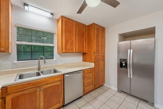 5903 Jack Stokes Rd, Baker, FL 32531 - kitchen featuring appliances with stainless steel finishes, light countertops, ceiling fan, a textured ceiling, and brown cabinets