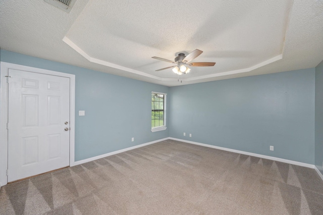 5903 Jack Stokes Rd, Baker, FL 32531 - empty room featuring a raised ceiling, ceiling fan, a textured ceiling, and carpet floors