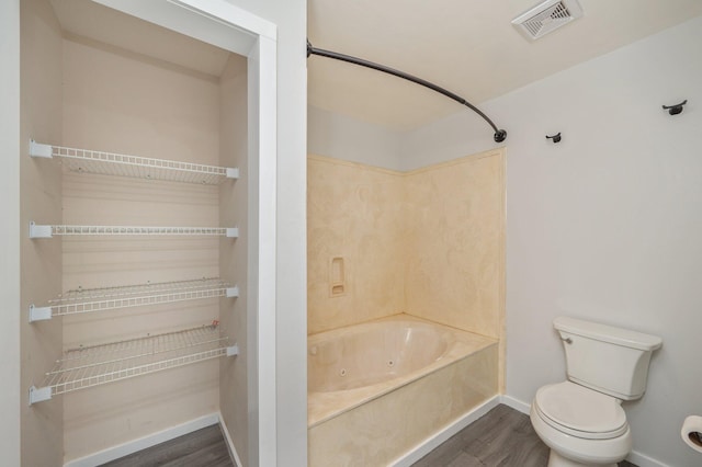 5903 Jack Stokes Rd, Baker, FL 32531 - bathroom with wood finished floors and a combined bath / shower with jetted tub
