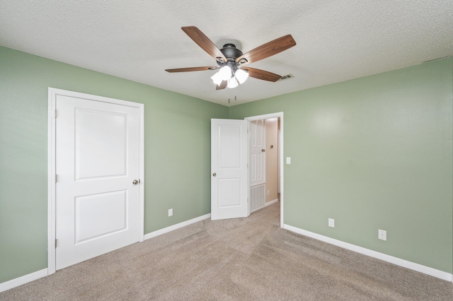 5903 Jack Stokes Rd, Baker, FL 32531 - unfurnished bedroom with carpet floors, a ceiling fan, and a textured ceiling