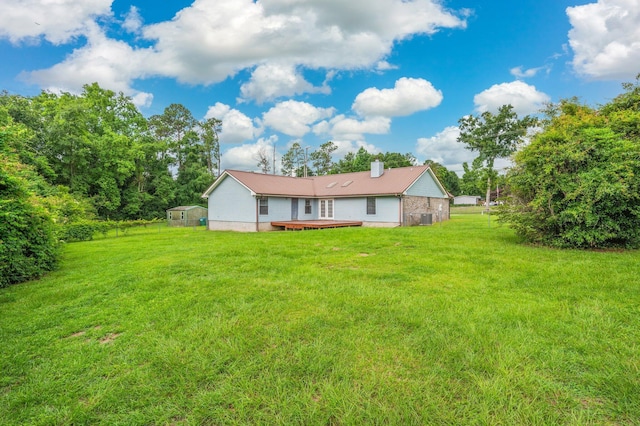 5903 Jack Stokes Rd, Baker, FL 32531 - rear view of property with a deck, a lawn, and a chimney