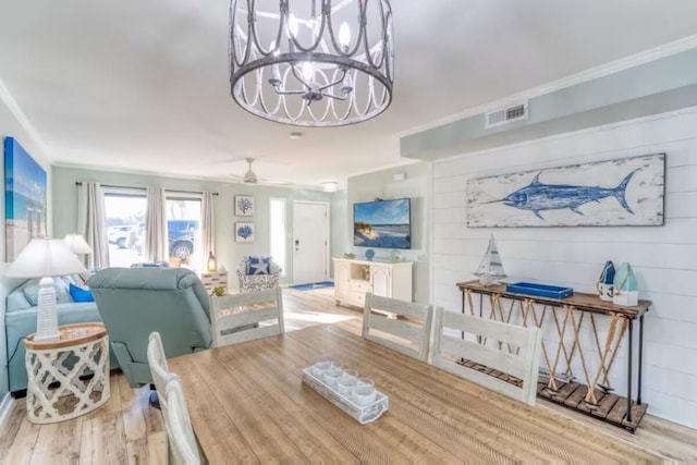 2800 Scenic Gulf Dr Unit 32, Miramar Beach, FL 32550 - dining area with wood finished floors, crown molding, a chandelier, and ceiling fan