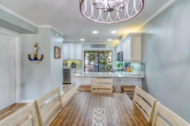 2800 Scenic Gulf Dr Unit 32, Miramar Beach, FL 32550 - kitchen with stainless steel appliances, light stone counters, decorative backsplash, ornamental molding, and recessed lighting