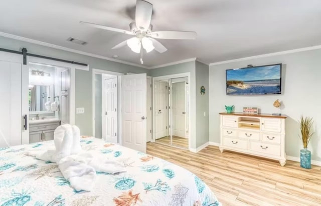 2800 Scenic Gulf Dr Unit 32, Miramar Beach, FL 32550 - bedroom with wood finished floors, crown molding, baseboards, connected bathroom, and a sink
