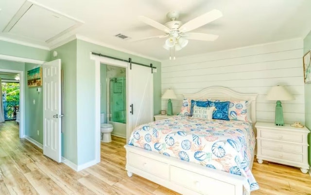 2800 Scenic Gulf Dr Unit 32, Miramar Beach, FL 32550 - bedroom featuring wood finished floors, ensuite bath, crown molding, a ceiling fan, and a barn door