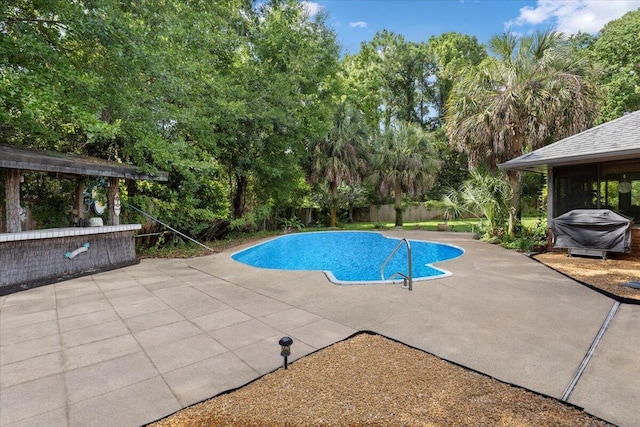 3995 Spanish Moss Cv, Gulf Breeze, FL 32563 - view of pool featuring a patio, area for grilling, a fenced backyard, and view of wooded area