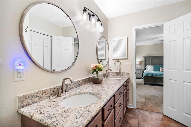 3995 Spanish Moss Cv, Gulf Breeze, FL 32563 - bathroom featuring double vanity, connected bathroom, and tile patterned floors