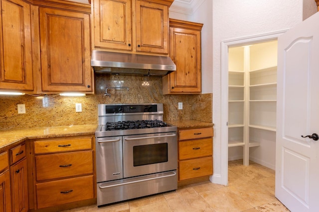 2007 Bayshore Dr, Niceville, FL 32578 - kitchen featuring range with two ovens, extractor fan, decorative backsplash, and brown cabinets