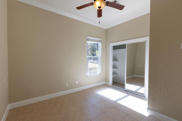 2007 Bayshore Dr, Niceville, FL 32578 - spare room featuring ornamental molding, a ceiling fan, a textured wall, and tile patterned flooring