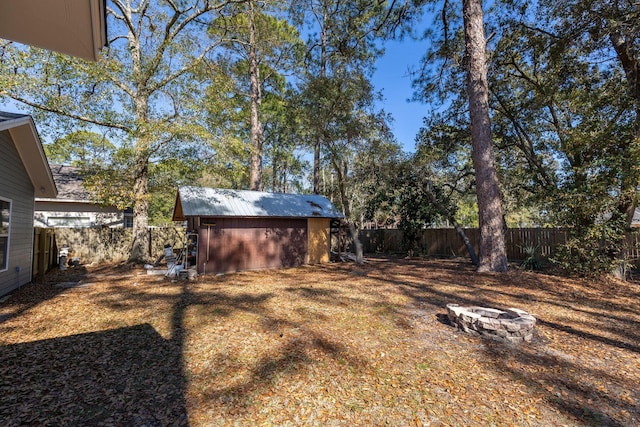 2007 Bayshore Dr, Niceville, FL 32578 - fenced backyard with a fire pit and an outbuilding