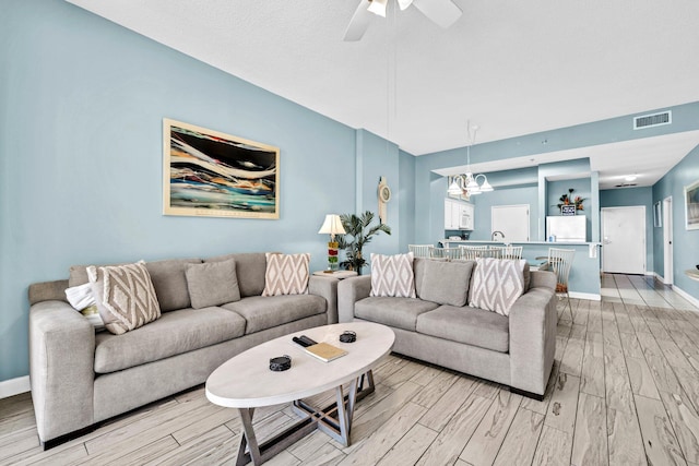 550 Tops L Beach Blvd # 102, Miramar Beach, FL 32550 - living room with wood finish floors, a chandelier, baseboards, and a ceiling fan