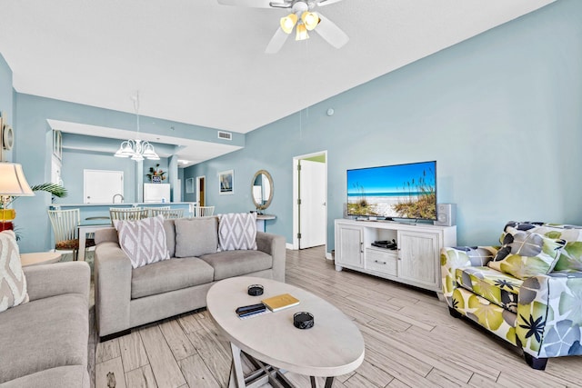 550 Tops L Beach Blvd # 102, Miramar Beach, FL 32550 - living room with light wood-type flooring, ceiling fan, a chandelier, and vaulted ceiling