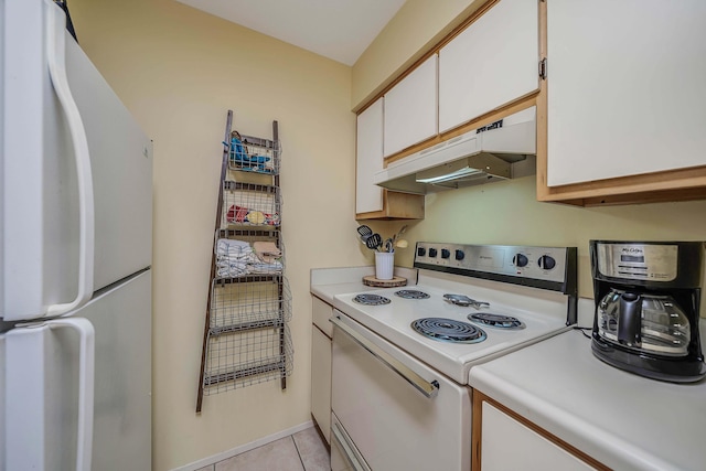 17614 Front Bch Unit E17, Panama City Beach, FL 32413 - kitchen with white appliances, under cabinet range hood, light countertops, white cabinetry, and light tile patterned floors