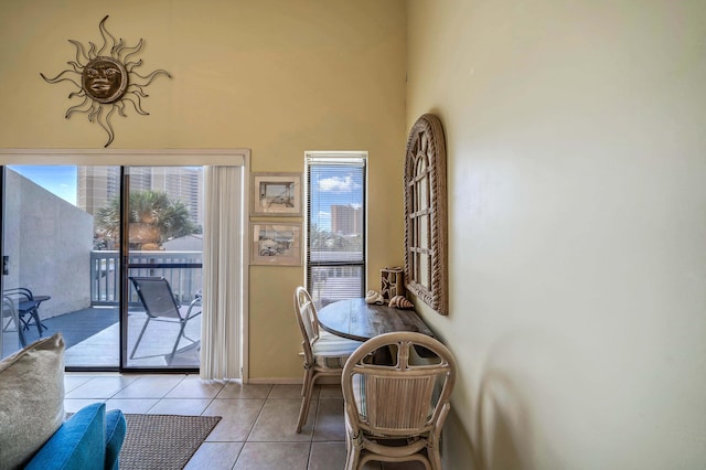 17614 Front Bch Unit E17, Panama City Beach, FL 32413 - dining area with light tile patterned flooring, baseboards, and a high ceiling