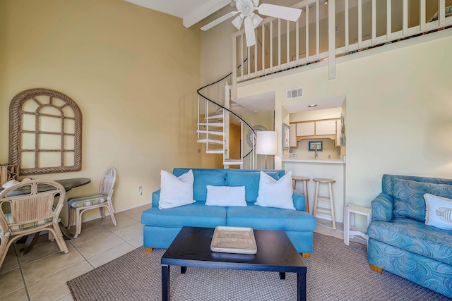 17614 Front Bch Unit E17, Panama City Beach, FL 32413 - tiled living area featuring a high ceiling, a ceiling fan, stairway, and baseboards