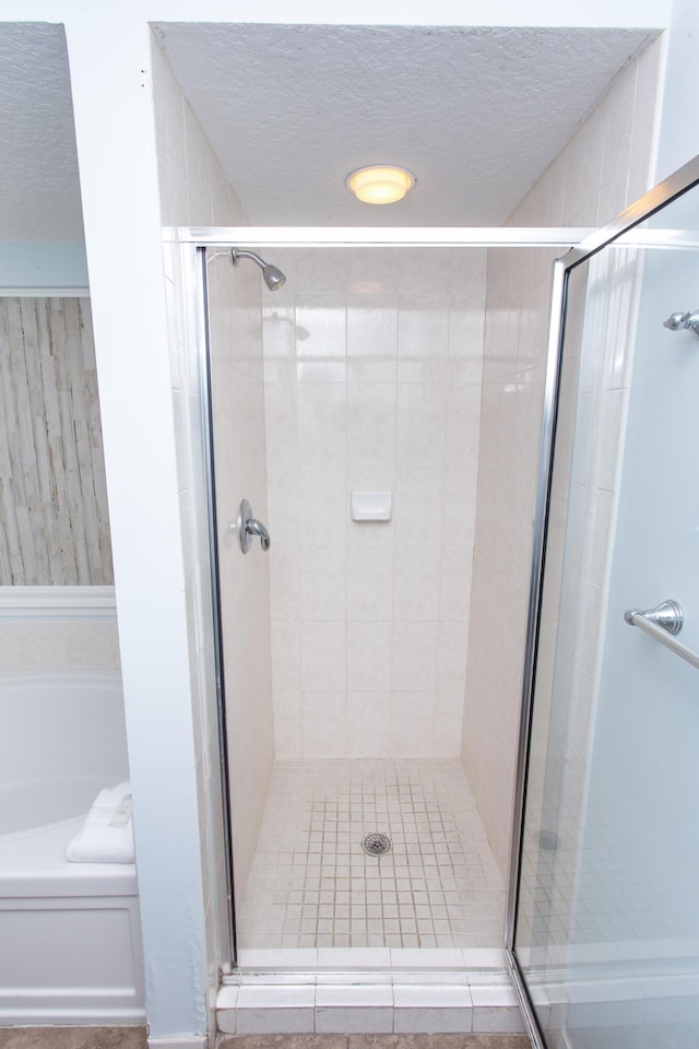 1517 Miracle Strip Pkwy Unit 403, Fort Walton Beach, FL 32548 - full bath with a shower stall, a garden tub, and a textured ceiling