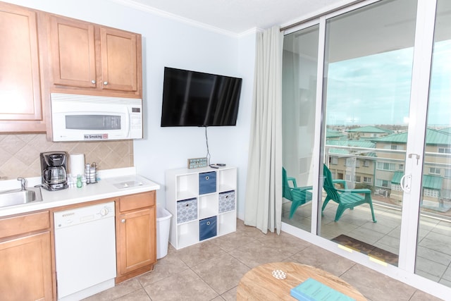 1517 Miracle Strip Pkwy Unit 403, Fort Walton Beach, FL 32548 - kitchen featuring white appliances, crown molding, decorative backsplash, light countertops, and a sink