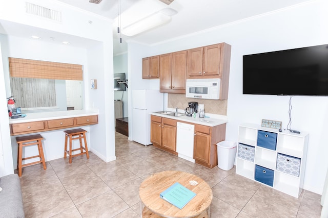 1517 Miracle Strip Pkwy Unit 403, Fort Walton Beach, FL 32548 - kitchen with white appliances, ornamental molding, tasteful backsplash, light tile patterned floors, and a sink
