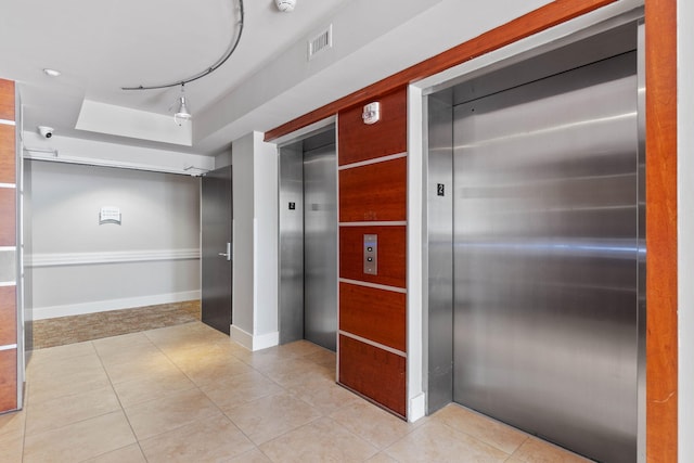 9700 Grand Sandestin Blvd Unit 4313, Miramar Beach, FL 32550 - hallway featuring elevator, light tile patterned flooring, and a tray ceiling