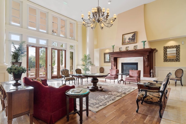 9700 Grand Sandestin Blvd Unit 4313, Miramar Beach, FL 32550 - living room featuring a towering ceiling, wood finished floors, french doors, a chandelier, and a premium fireplace