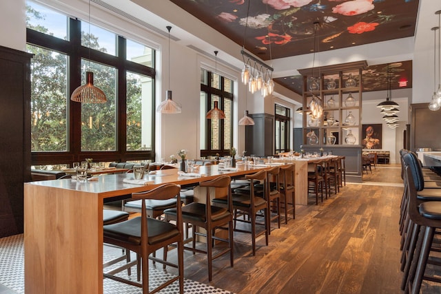 9700 Grand Sandestin Blvd Unit 4313, Miramar Beach, FL 32550 - bar featuring a high ceiling, wood finished floors, a chandelier, and hanging light fixtures