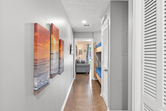 2384 Scenic Gulf Dr Unit 112, Miramar Beach, FL 32550 - hall with a textured ceiling, tile patterned flooring, and baseboards