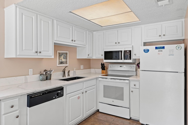 2384 Scenic Gulf Dr Unit 112, Miramar Beach, FL 32550 - kitchen with white appliances, a sink, white cabinetry, a textured ceiling, and tile patterned flooring