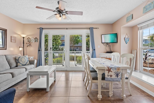 2384 Scenic Gulf Dr Unit 112, Miramar Beach, FL 32550 - tiled dining room featuring ceiling fan and a textured ceiling