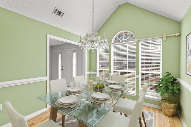 7 Citation Dr, Shalimar, FL 32579 - dining space with wood finished floors, vaulted ceiling, and a chandelier