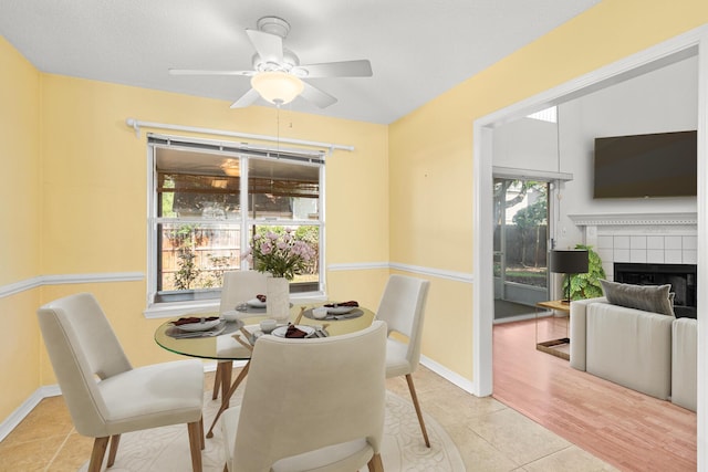7 Citation Dr, Shalimar, FL 32579 - tiled dining space with a ceiling fan and a fireplace