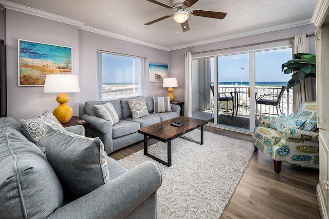 376 Santa Rosa Blvd Unit 101, Fort Walton Beach, FL 32548 - living room featuring a ceiling fan, wood finished floors, a water view, ornamental molding, and a textured ceiling
