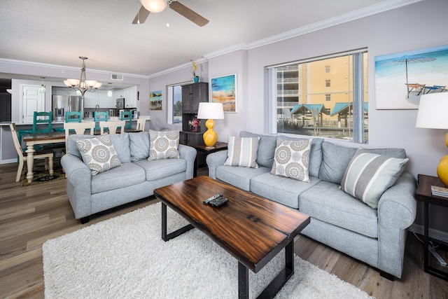 376 Santa Rosa Blvd Unit 101, Fort Walton Beach, FL 32548 - living room with a ceiling fan, a chandelier, wood finished floors, and ornamental molding