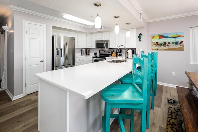 376 Santa Rosa Blvd Unit 101, Fort Walton Beach, FL 32548 - kitchen featuring appliances with stainless steel finishes, a sink, crown molding, a peninsula, and dark wood-type flooring