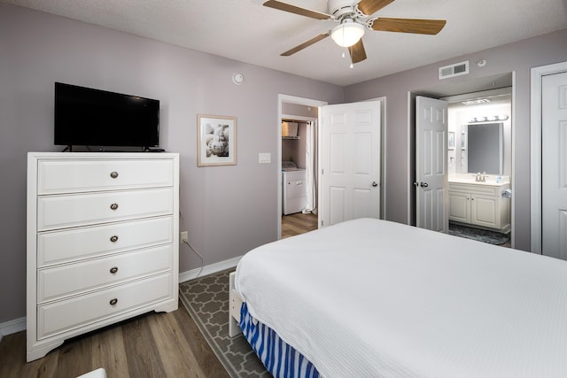 376 Santa Rosa Blvd Unit 101, Fort Walton Beach, FL 32548 - bedroom with dark wood-style flooring, baseboards, ensuite bathroom, and a ceiling fan