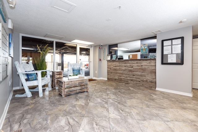 376 Santa Rosa Blvd Unit 101, Fort Walton Beach, FL 32548 - living room featuring attic access, baseboards, and a textured ceiling