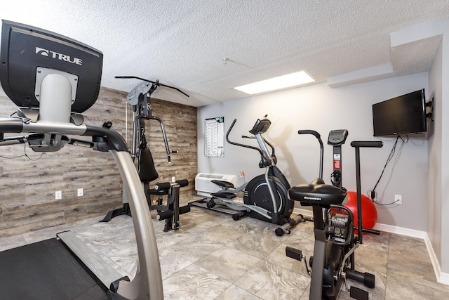 376 Santa Rosa Blvd Unit 101, Fort Walton Beach, FL 32548 - exercise area with wooden walls, a textured ceiling, and baseboards