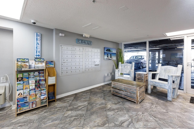376 Santa Rosa Blvd Unit 101, Fort Walton Beach, FL 32548 - living area featuring mail area, a textured ceiling, and baseboards