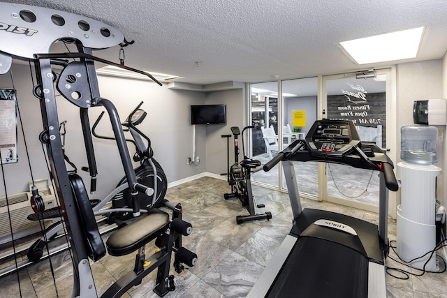 376 Santa Rosa Blvd Unit 101, Fort Walton Beach, FL 32548 - workout room featuring a textured ceiling and baseboards