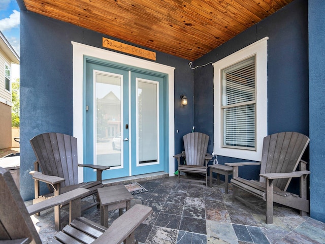 216 Tahitian Way, Destin, FL 32541 - doorway to property with stucco siding and a patio area