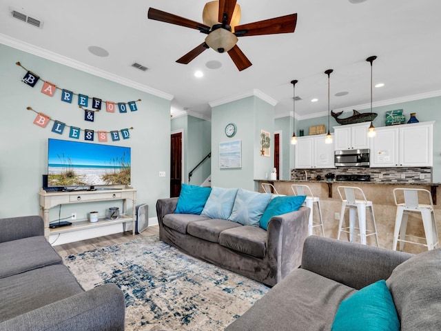 216 Tahitian Way, Destin, FL 32541 - living room featuring ornamental molding, a ceiling fan, stairs, wood finished floors, and recessed lighting