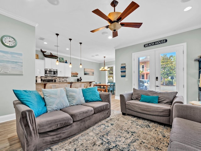 216 Tahitian Way, Destin, FL 32541 - living room with light wood-style flooring, ornamental molding, a chandelier, baseboards, and ceiling fan
