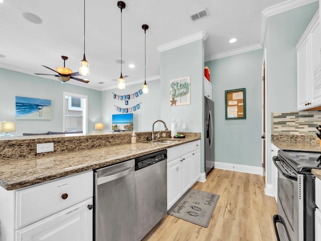 216 Tahitian Way, Destin, FL 32541 - kitchen with a sink, appliances with stainless steel finishes, ornamental molding, tasteful backsplash, and light wood-style flooring