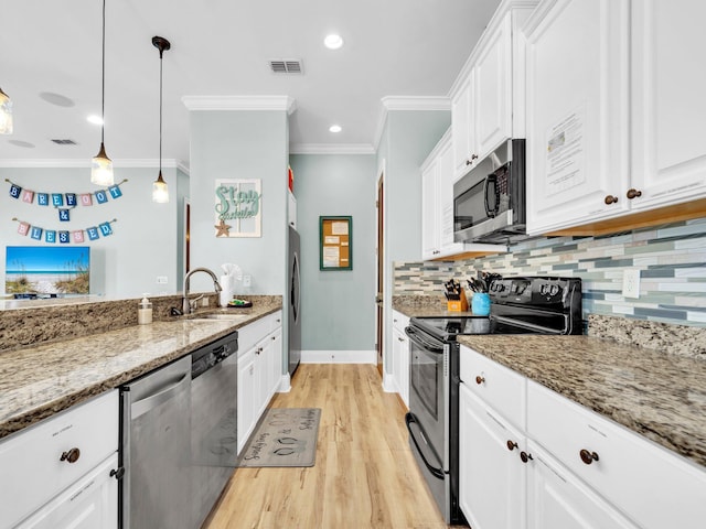 216 Tahitian Way, Destin, FL 32541 - kitchen with appliances with stainless steel finishes, a sink, crown molding, backsplash, and white cabinetry