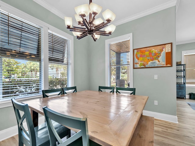 216 Tahitian Way, Destin, FL 32541 - dining room with a chandelier, baseboards, light wood-style flooring, and crown molding