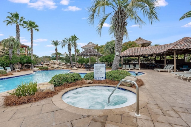 216 Tahitian Way, Destin, FL 32541 - community pool featuring a gazebo, a community hot tub, and a patio area