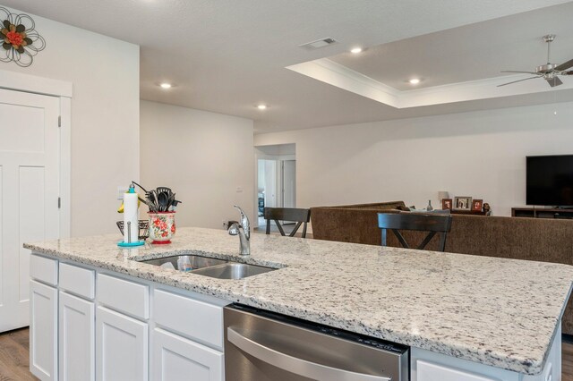 125 Hobson Ave, Crestview, FL 32539 - kitchen with stainless steel dishwasher, open floor plan, a sink, dark wood-type flooring, and white cabinetry