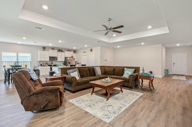 125 Hobson Ave, Crestview, FL 32539 - living area featuring a raised ceiling, crown molding, a ceiling fan, light wood-style flooring, and recessed lighting