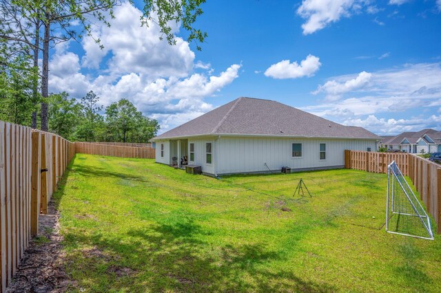 125 Hobson Ave, Crestview, FL 32539 - rear view of property with a fenced backyard and a shingled roof